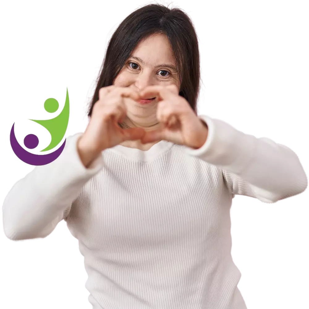 Disabled girl with down syndrome making love heart shape with hands and smiling at camera
