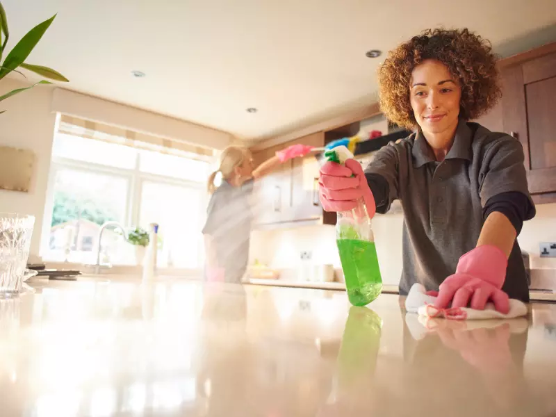 Two women cleaning kitchen